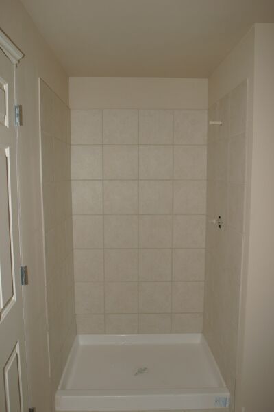 Slate tile covers the shower in the master bath