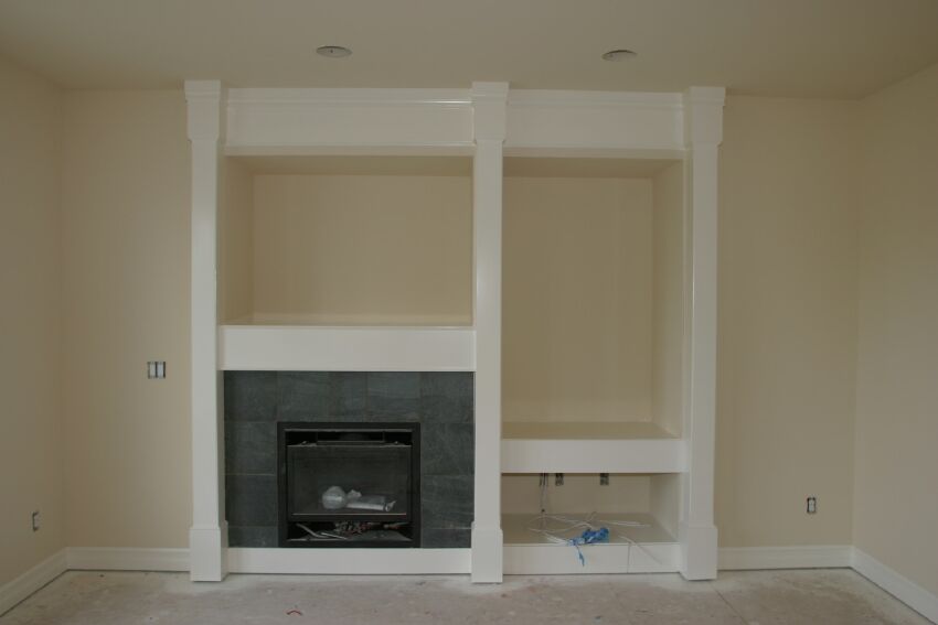 Fireplace and media niche with finish trim and paint