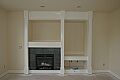 Fireplace and media niche with finish trim and paint